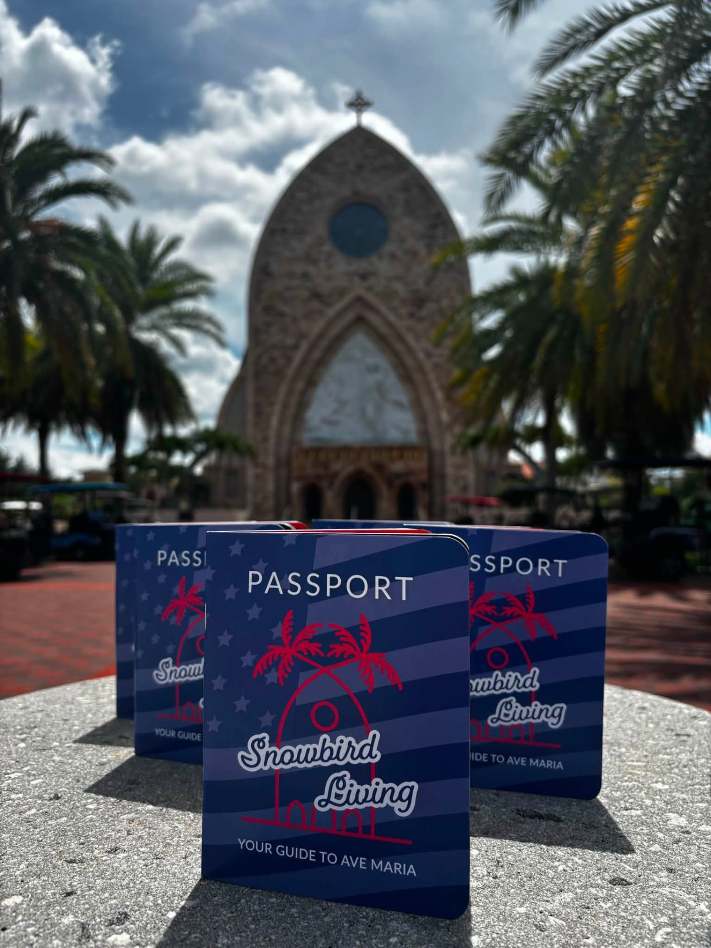 Printed Snowbird Living Passports in front of the Ave Maria church